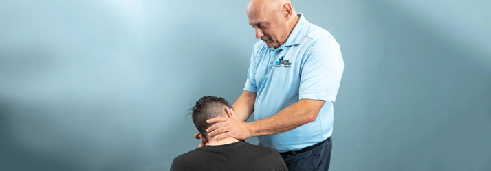 Chiropractor Baltimore MD Mark Stutman Assisting Patient With Neck Pain