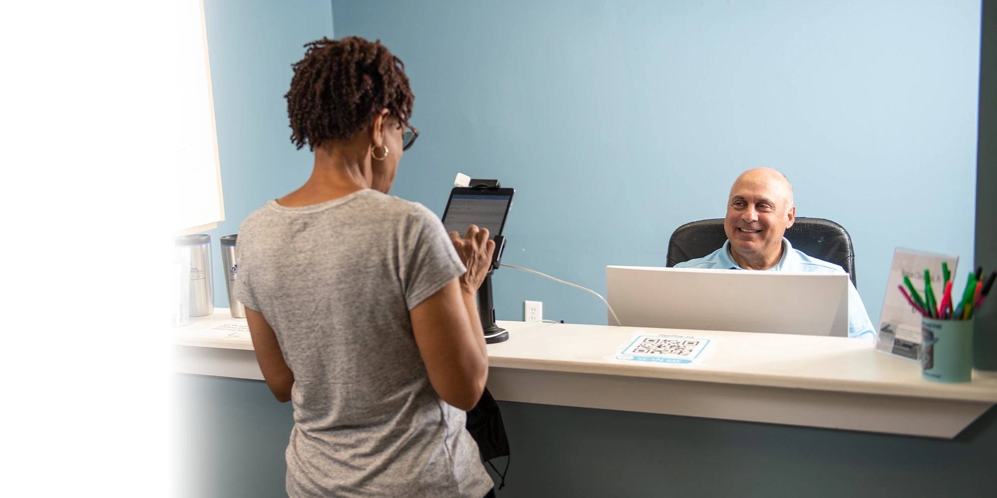 Chiropractor Baltimore MD Mark Stutman Checking Patient In