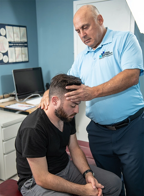 Chiropractor Takoma Park MD Mark Stutman Assessing Patients Neck Chiropractor Takoma Park MD Mark Stutman Assessing Patients Neck