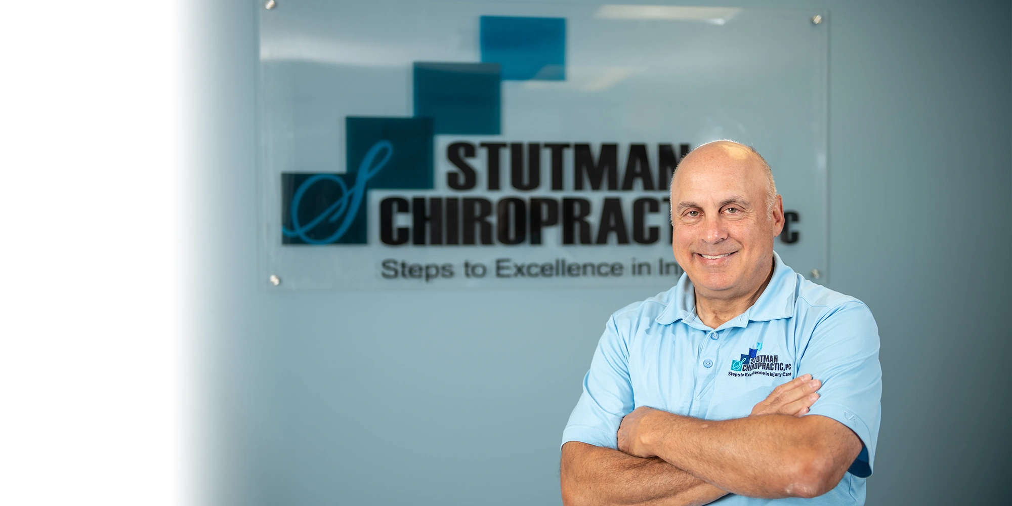 Chiropractor Takoma Park MD Mark Stutman In Front Of Sign