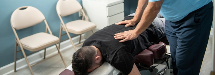 Chiropractor Takoma Park MD Mark Stutman Performing Adjustment Chiropractor Takoma Park MD Mark Stutman Performing Adjustment
